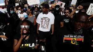 Rapper YG, center in white, at a June 7 protest over the death of George Floyd.