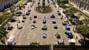 Rectangles designed to help prevent the spread of the coronavirus by encouraging social distancing line a city-sanctioned homeless encampment at San Francisco's Civic Center on May 21