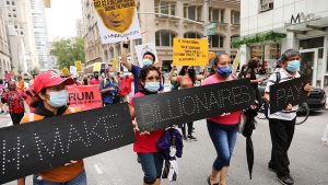 People participate in a "March on Billionaires" event on July 17 in New York City.