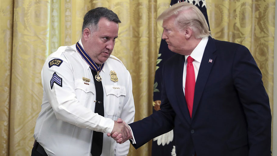 President Donald Trump presents the Medal of Valor to Dayton Police Sgt. William Knight on Monday for helping to stop a mass shooter in August.