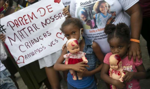 Stop-killing-our-children-portuguese-brazil-protest-910x512