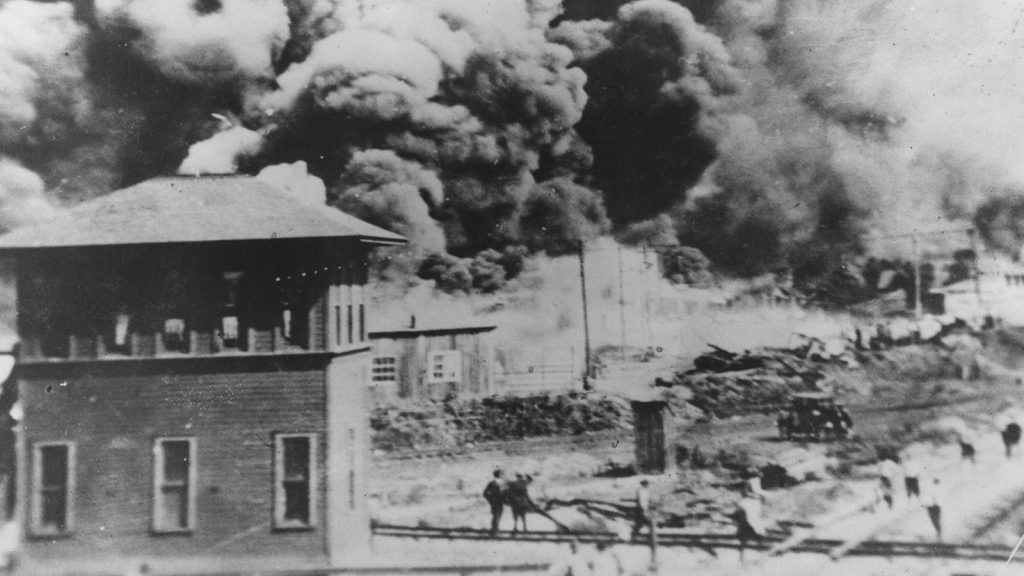 Smoke rises north of Greenwood Avenue from Hartford Avenue, in Tulsa, Okla. on June 1, 1921.
