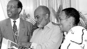 Dr. Ron Daniels and his wife Mary France-Daniels presented President Préval with a book about South African leader Nelson Mandela.