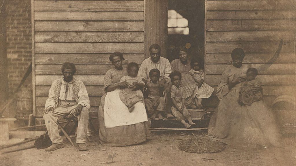 An enslaved African American family or families pose on the plantation of Dr. William F. Gaines in Hanover County, Virginia, 1862.