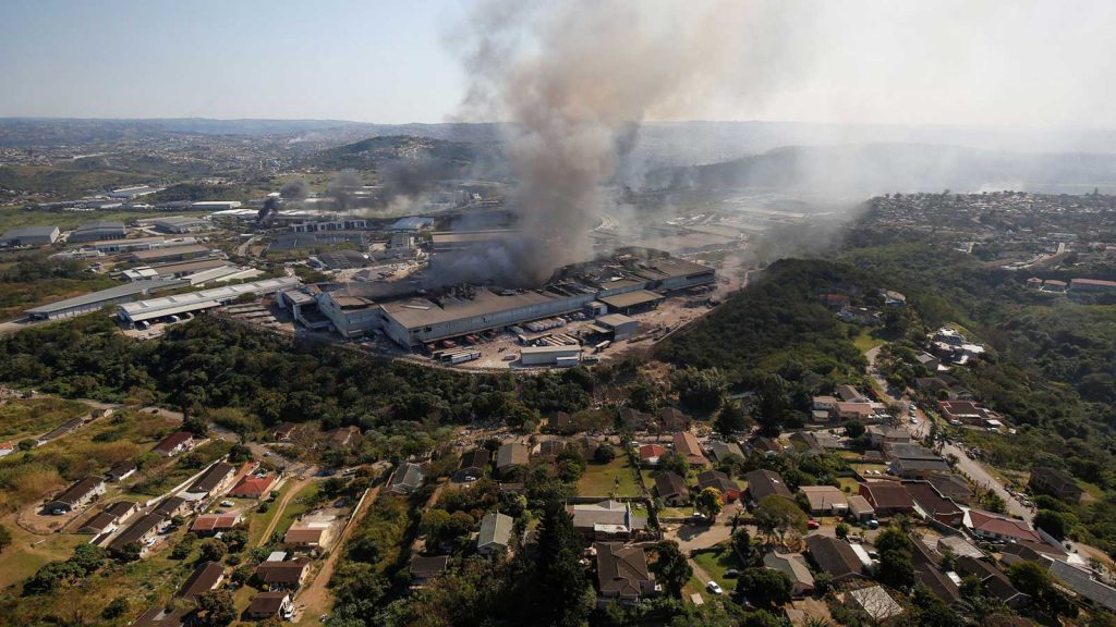 A warehouse smolders in Durban, South Africa, after supporters of former President Jacob Zuma erupted in violence earlier this month when Zuma was jailed.