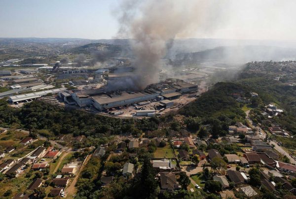 A warehouse smolders in Durban, South Africa, after supporters of former President Jacob Zuma erupted in violence earlier this month when Zuma was jailed.