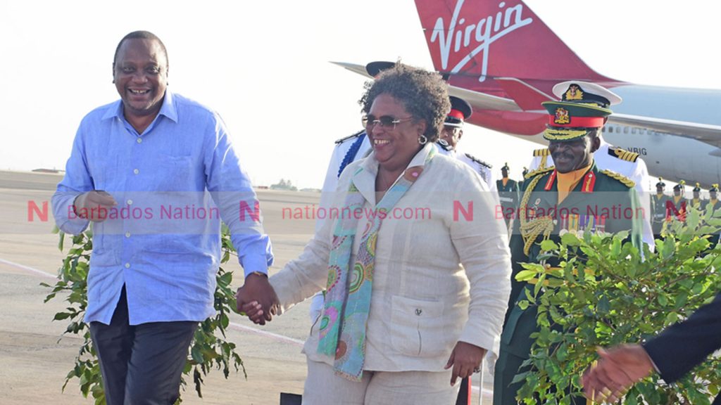 Prime Minister Mia Mottley and Kenyan president Uhuru Kenyatta holding hands before he left the island after a three-day official visit in 2019.