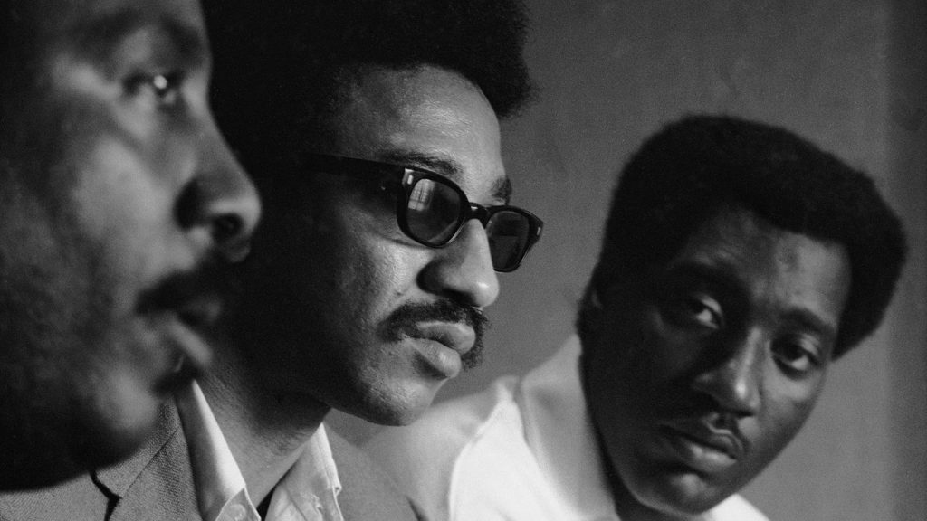 Civil rights activist Dick Gregory, left, and musician Otis Redding flank H. Rap Brown at an August 1967 convention in Atlanta