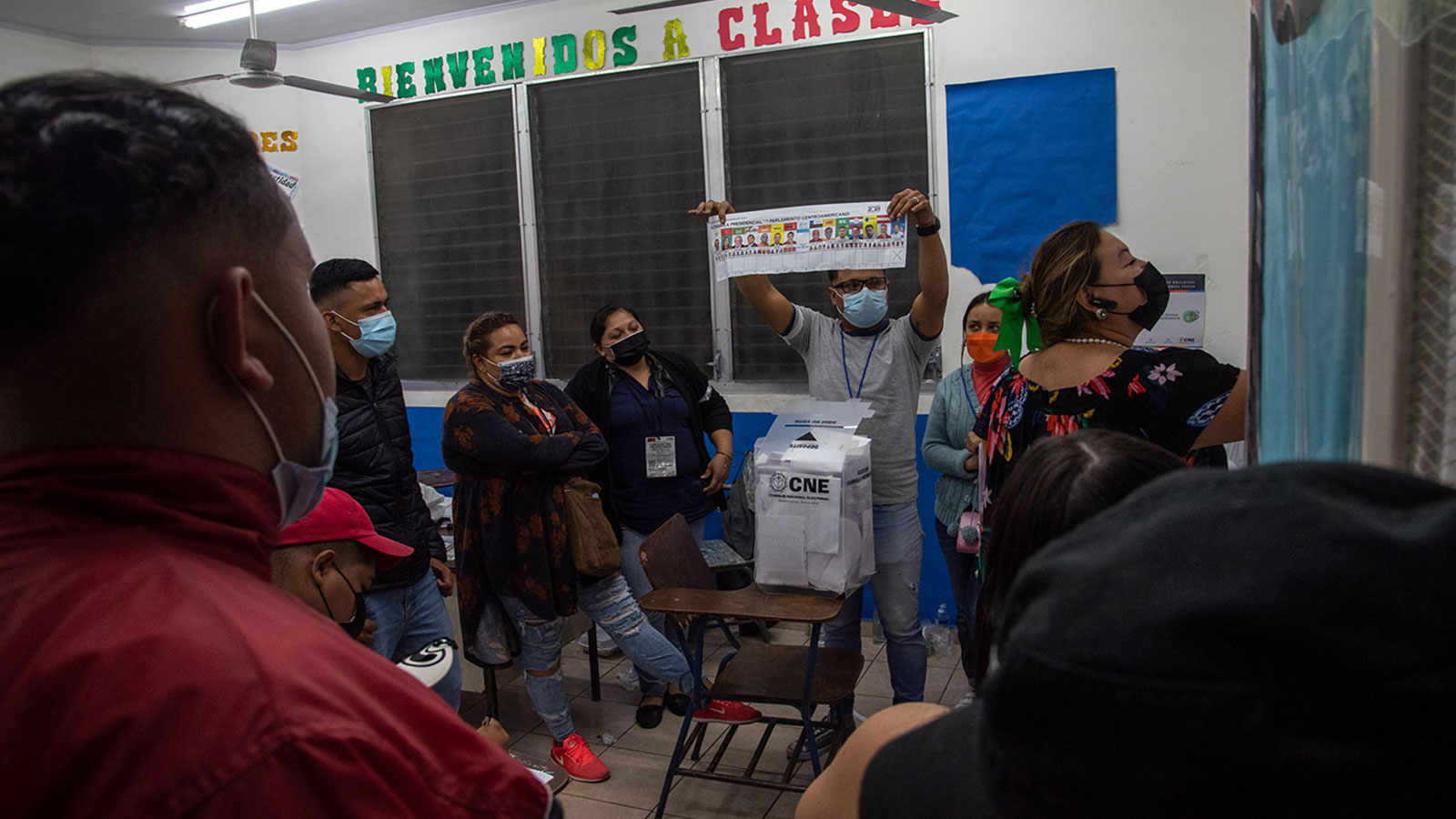 A poll worker displays a finished ballot to voters in Tegucigalpa, Honduras.