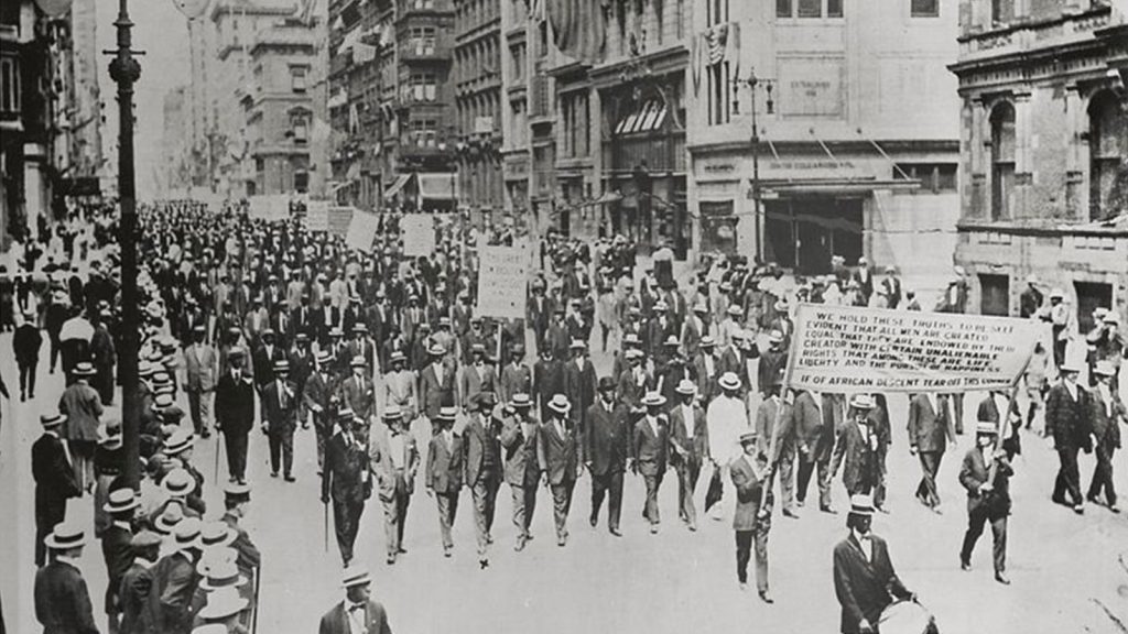 Silent Protest parade on Fifth Avenue, New York City, July 28, 1917, in response to the East St. Louis race riot: In front row are James Weldon Johnson (far right), W. E. B. DuBois (2nd from right), Rev. Hutchens Chew Bishop, rector of St. Philip's Episcopal Church (Harlem) and realtor John E. Nail. (New York Public Library)