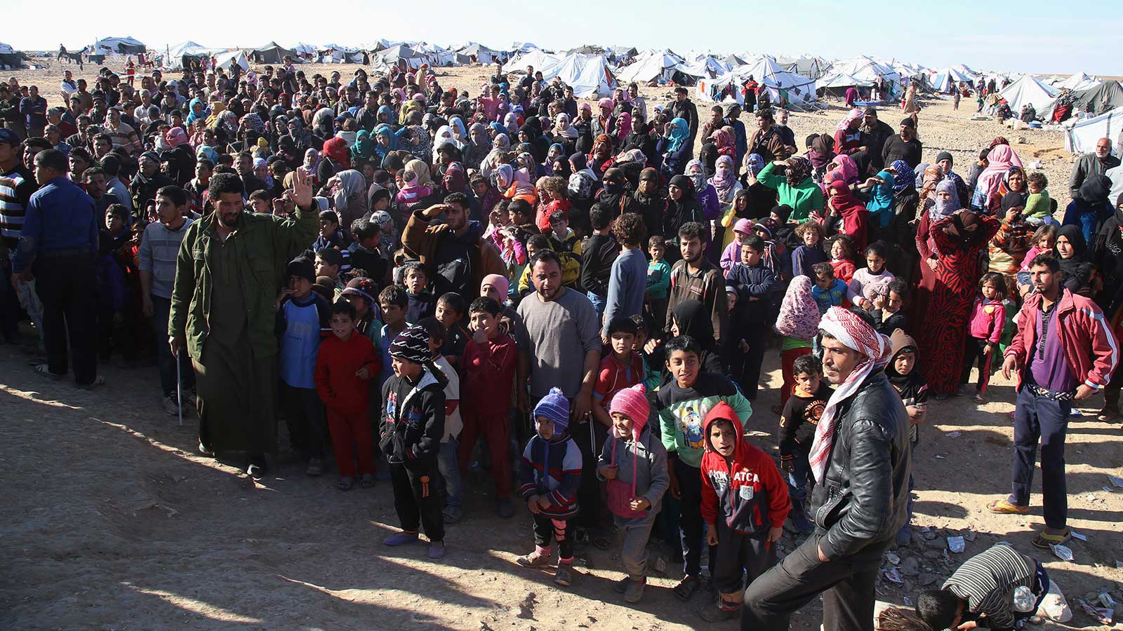 Few Syrian refugees were allowed into the U.S. In this photo, Syrian refugees wait to be approved to get into Jordan.