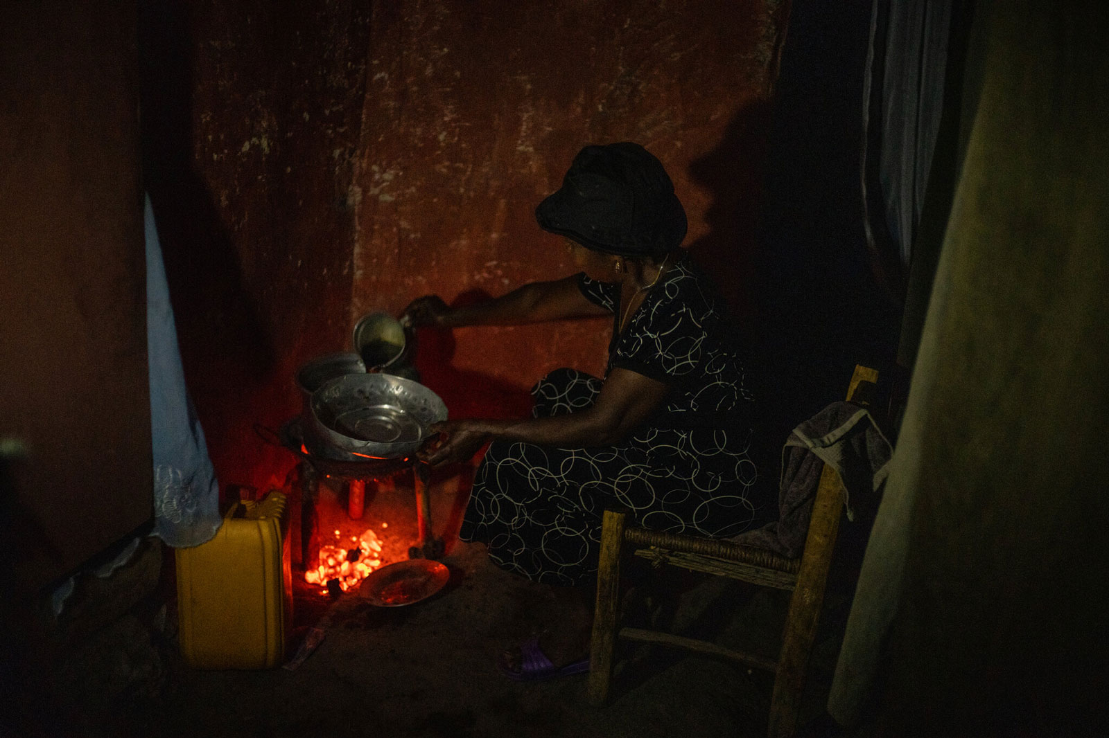 Adrienne Present preparing coffee early in the morning at her house in Dondon, Hait