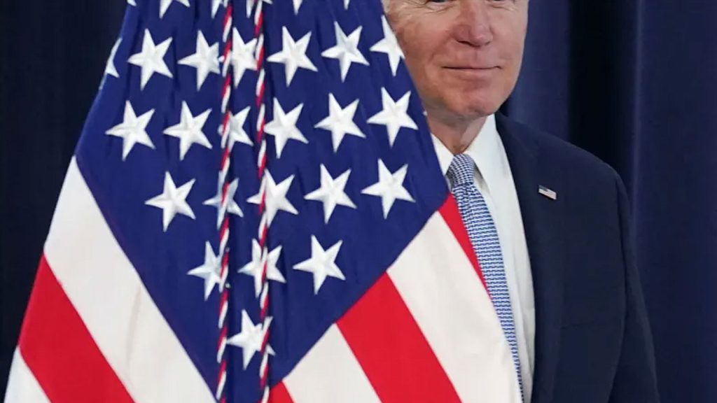 Biden behind American flag