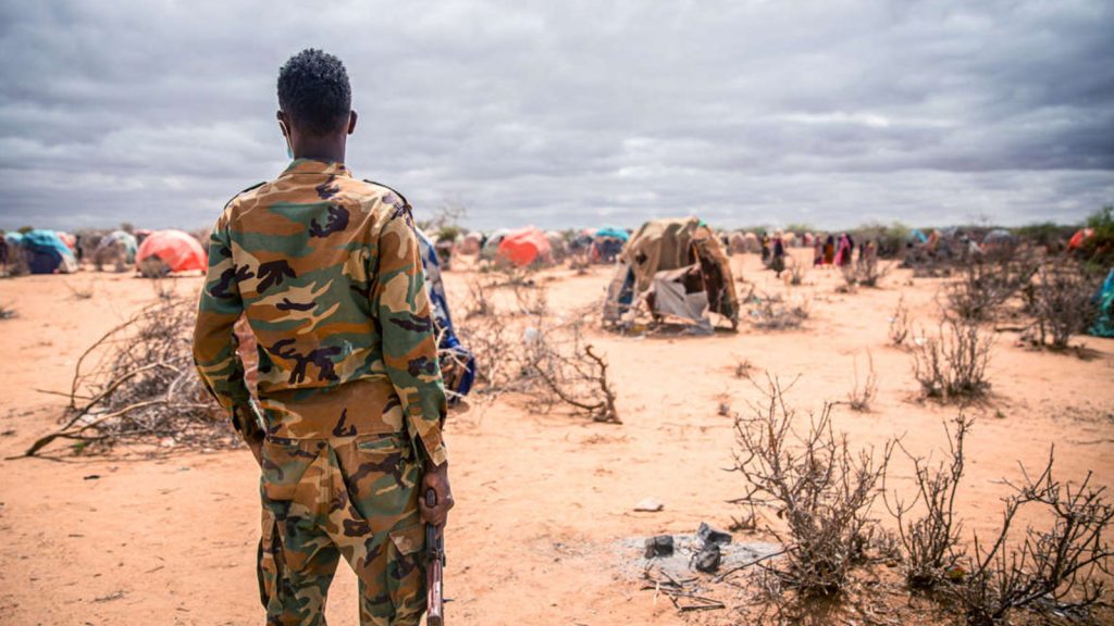 A soldier surveys a camp for displaced people on the outskirts of Jubaland, Somalia, on March 14, 2022