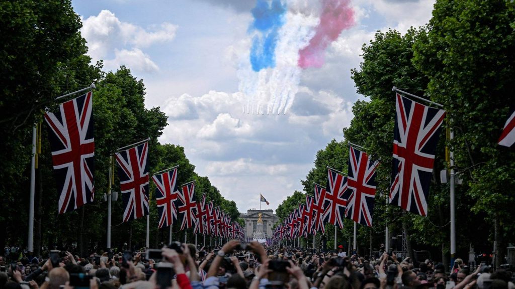 People watch planes fly over Buckingham Palace during celebrations marking the Platinum Jubilee of Britain's Queen Elizabeth II in London on June 2.