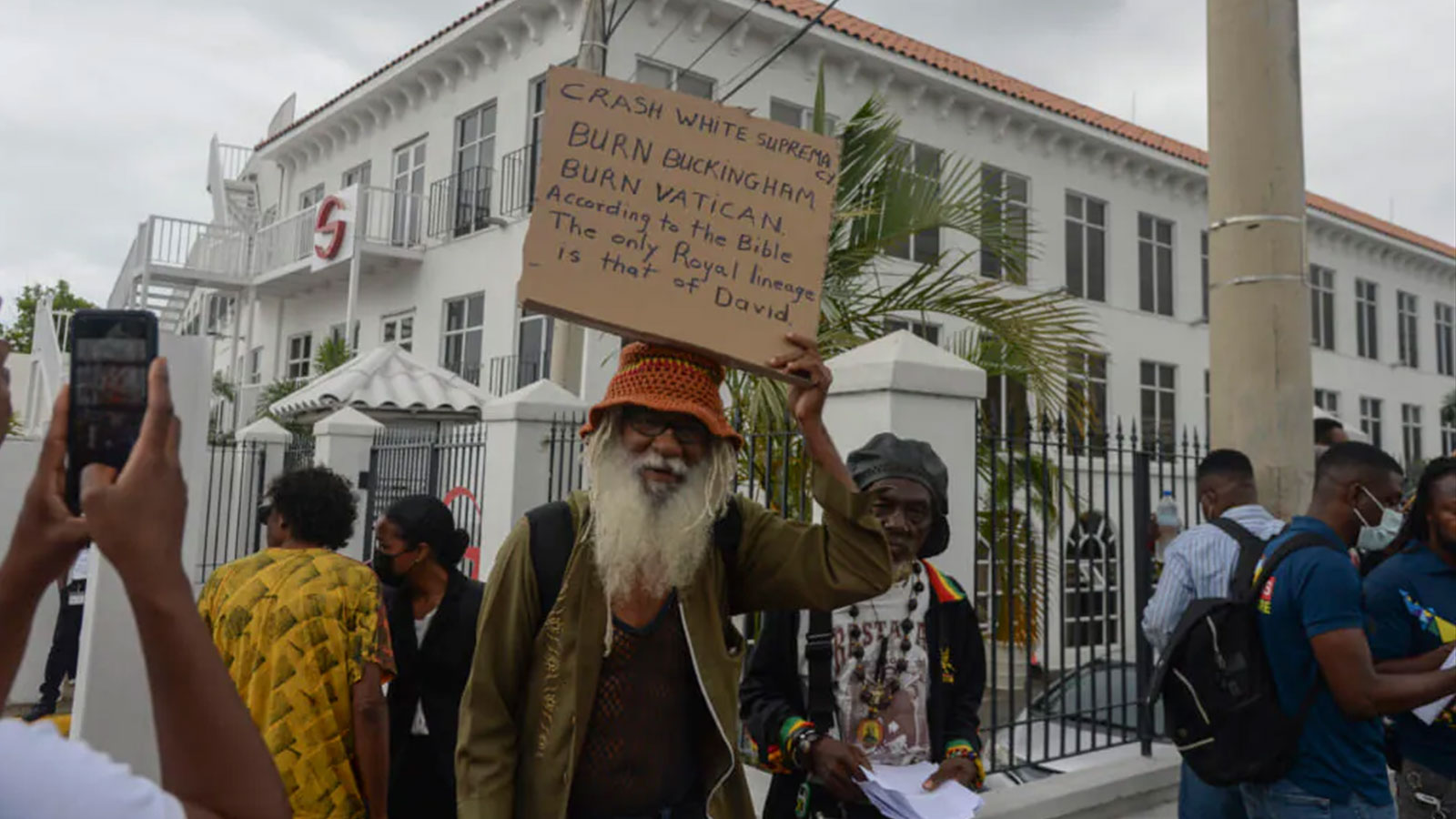 People protest to demand an apology and slavery reparations during a visit to the former British colony by the Duke and Duchess of Cambridge, Prince William and Kate, in Kingston, Jamaica, Tuesday, March 22, 2022. 