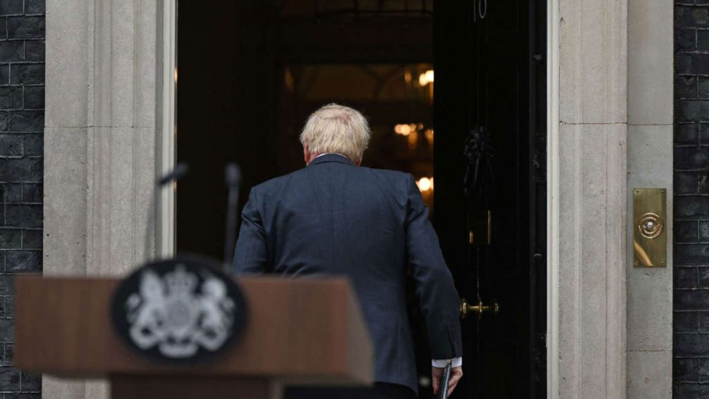 Britain's Prime Minister Boris Johnson walks back into 10 Downing Street in central London after making a statement on July 7, 2022