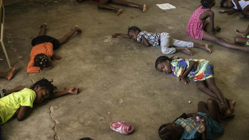 Children sleep on the floor of a school turned into a shelter after they were forced to leave their homes in Cite Soleil due to clashes between armed gangs, in Port-au-Prince, Haiti, Saturday, July 23, 2022.