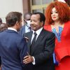 Cameroonian President Paul Biya shakes hands with French President Emmanuel Macron as Biya's wife, Chantal, looks on, after their meeting at the presidential palace, in Yaounde, Cameroon, on July 26.
