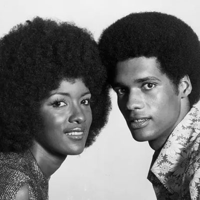 A studio portrait of an African American couple, taken in the mid-1970s. 