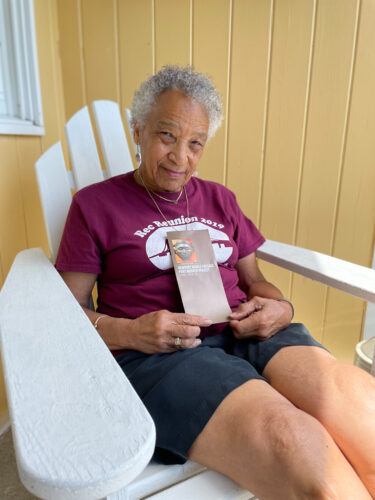Victoria Johnson holds a brochure from the Newport Middle Passage Port Marker Project, an initiative she co-founded to memorialize the contributions of early Black residents and to recognize the city’s role in the slave trade.