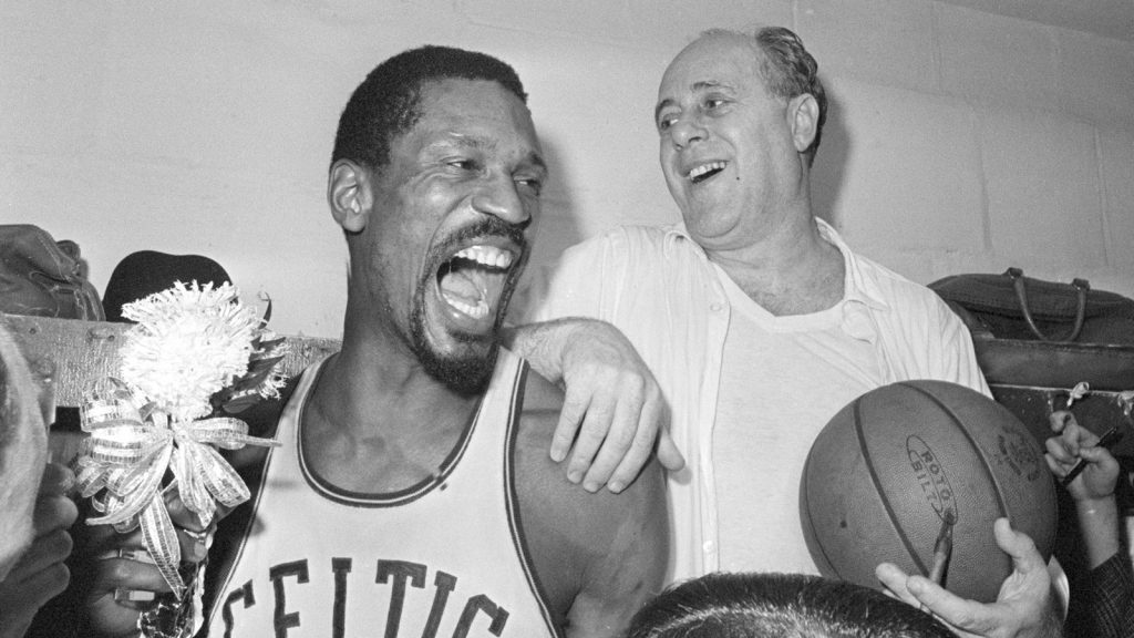 Bill Russell, left, celebrates with Celtics coach Red Auerbach after defeating the Los Angeles Lakers to win their eighth-straight NBA Championship, in Boston, April 29, 1966.