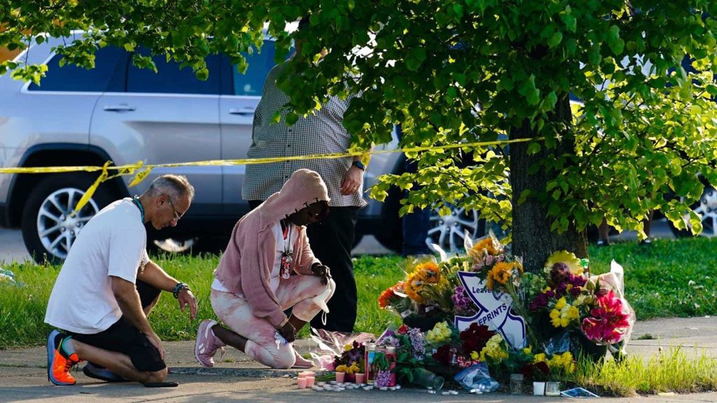 People pay their respects outside the scene of a shooting at a supermarket in Buffalo, N.Y., Sunday, May 15, 2022.