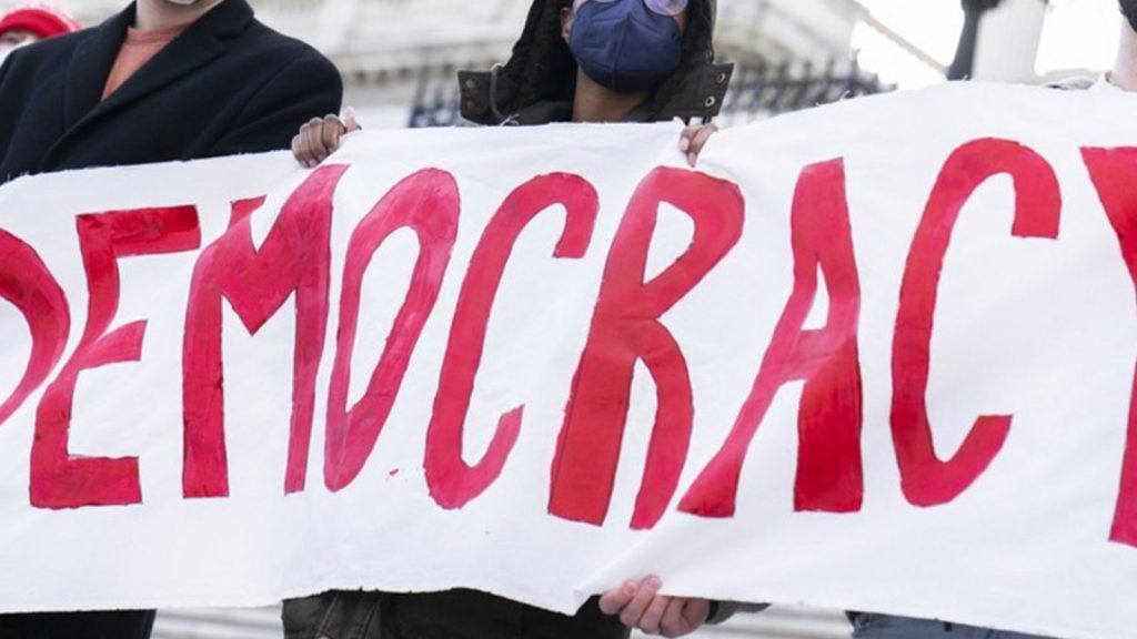 Demonstrators hold a sign at rally with Rep. Jamaal Bowman (D-N.Y.) outside the U.S. Capitol to urge the Senate to pass voting rights legislation on Wednesday, January 19, 2022.