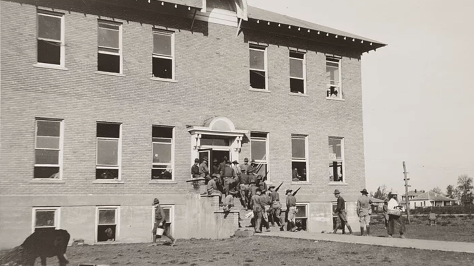 Soldiers of the 57th Infantry of the 3rd Division from Camp Pike in Little Rock carry rifles as they enter a guardhouse and hospital after being dispatched to Elaine in 1919. 
