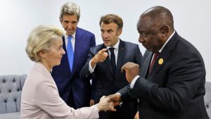 Ursula von der Leyen, President of the European Commission, and South African President Cyril Ramaphosa greet each other at COP27 as Emanuel Macron, President of France, and John Kerry, US special envoy for the climate, look on.