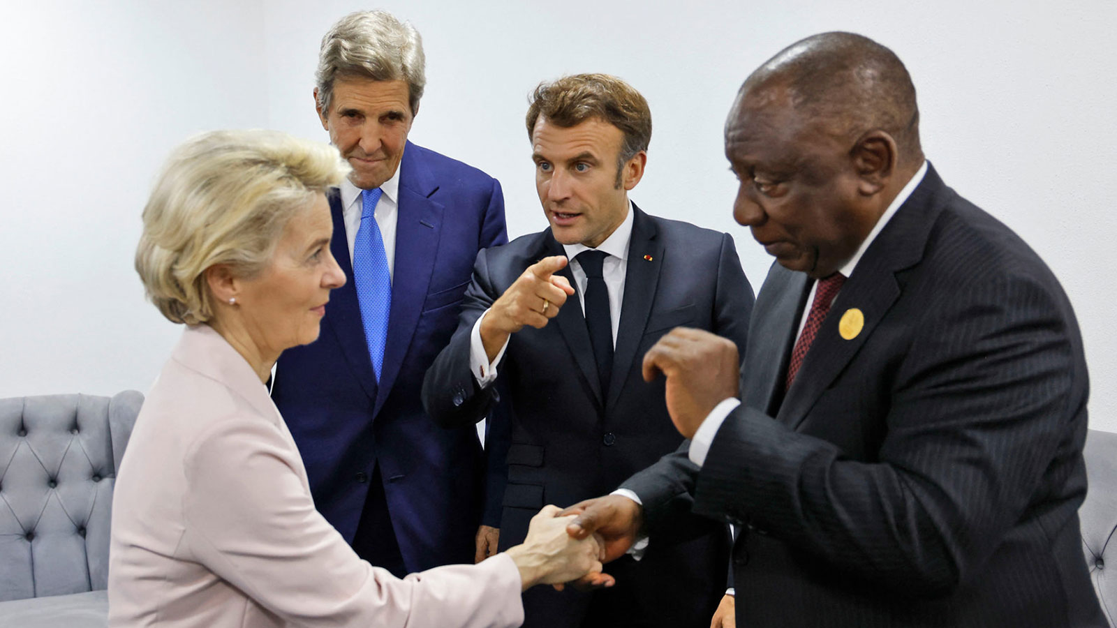 Ursula von der Leyen, President of the European Commission, and South African President Cyril Ramaphosa greet each other at COP27 as Emanuel Macron, President of France, and John Kerry, US special envoy for the climate, look on. 