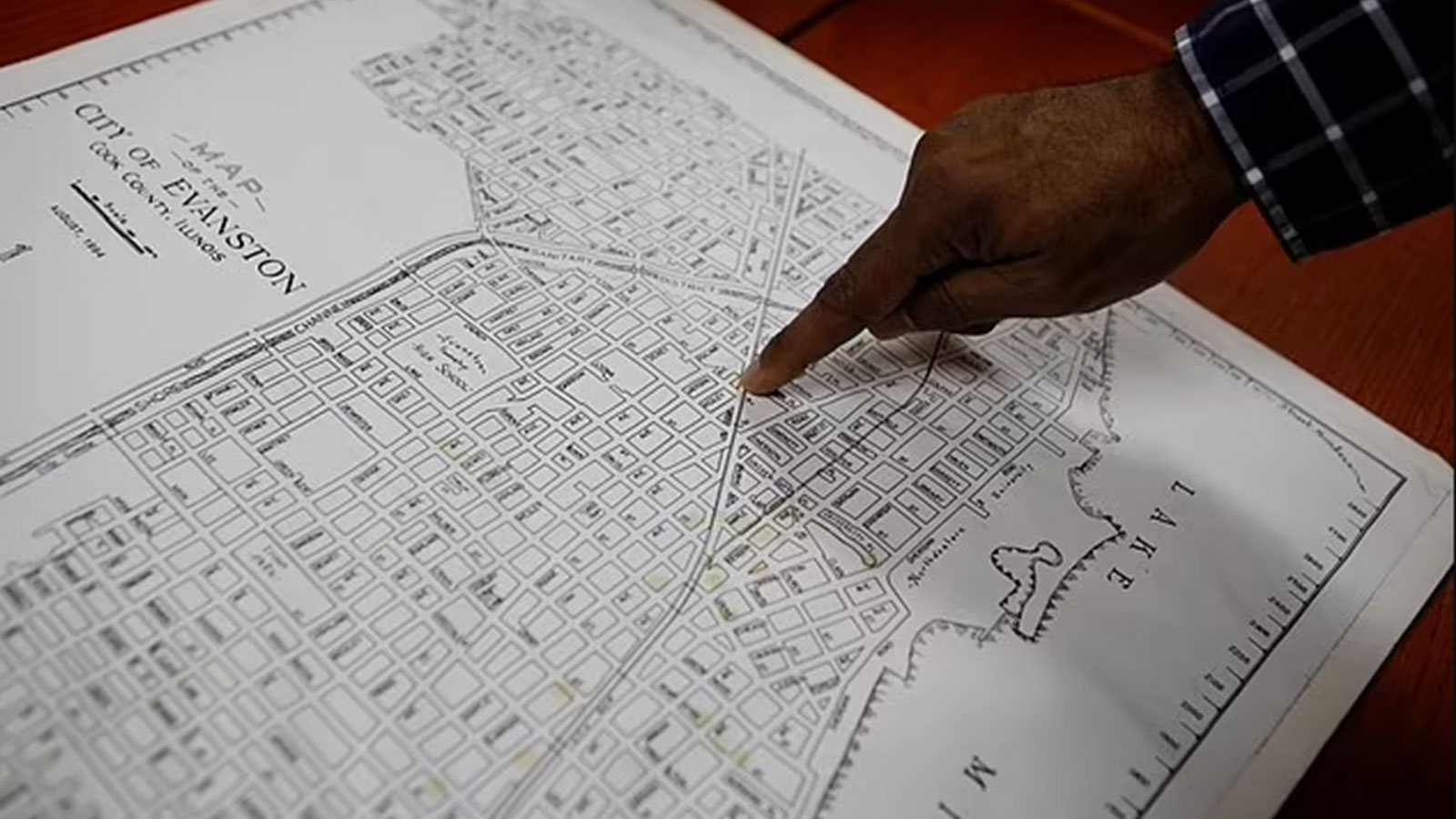 Community historian Morris 'Dino' Robinson, points to the borders of the Fifth Ward, which was the area of Evanston the city's Black citizens were forced to move to due to redlining between 1919 and 1969