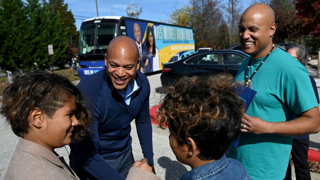 Gubernatorial candidate Wes Moore greets future voters with their father Krios Auld, right, at Bonnie Branch Middle School on Election Day 2022 in Ellicott City, Md. Moore defeated Republican Dan Cox, in the process becoming the first Black governor of Maryland.