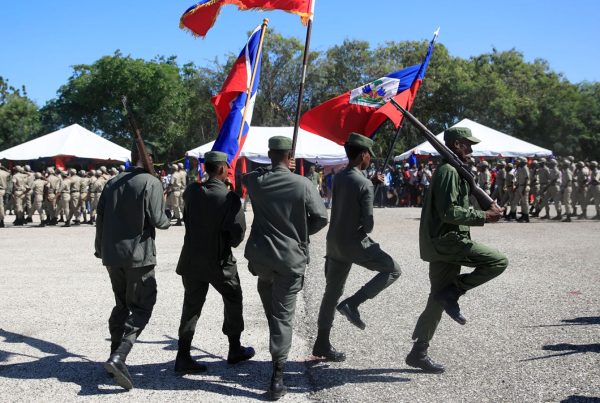 Haiti - Soldiers marching with Hattian flag.