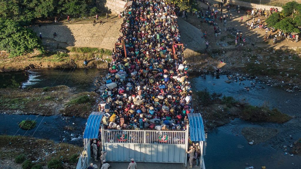 Haitians wait to cross the border between the Dominican Republic and Haiti in Dajabon, Dominican Republic, Friday, November 19, 2021.