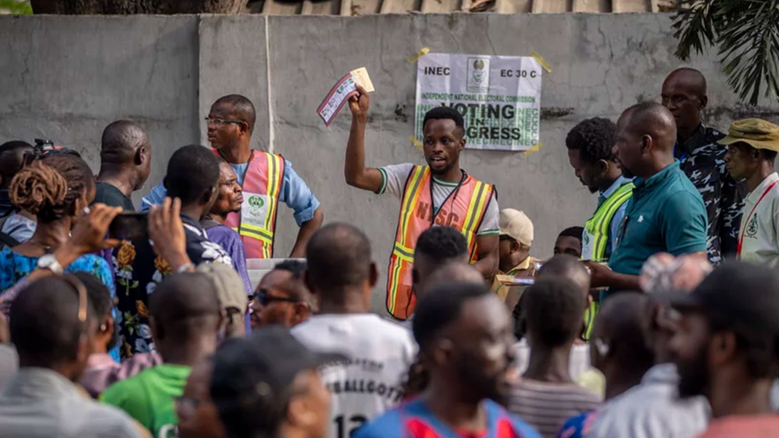 An electoral officer holds up votes as they are counted at a polling station in Lagos, Nigeria.