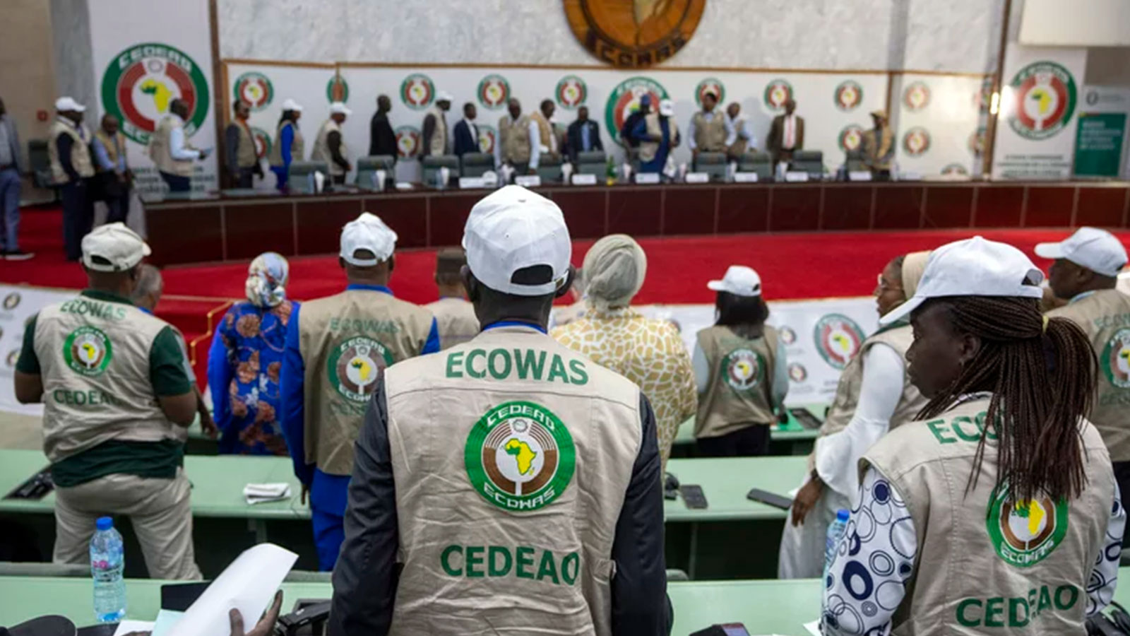 Members stand for the arrival of dignitaries at a joint press conference by African Union (AU) and Economic Community of West African States (ECOWAS) electoral observers in Abuja, Nigeria. 