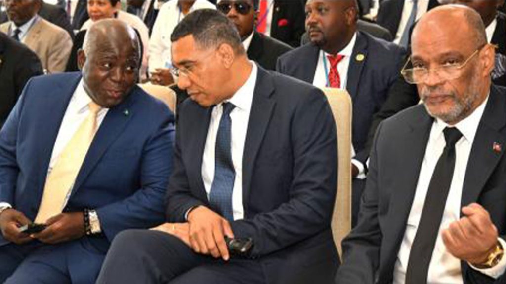 Prime Minister Andrew Holness (centre) speaks with Bahamas Prime Minister Philip Davis (left) while Haiti Prime Minister Ariel Henry looks on during the opening ceremony of the Haiti Security Talks at the Ministry of Foreign Affairs and Foreign Trade in Kingston yesterday.