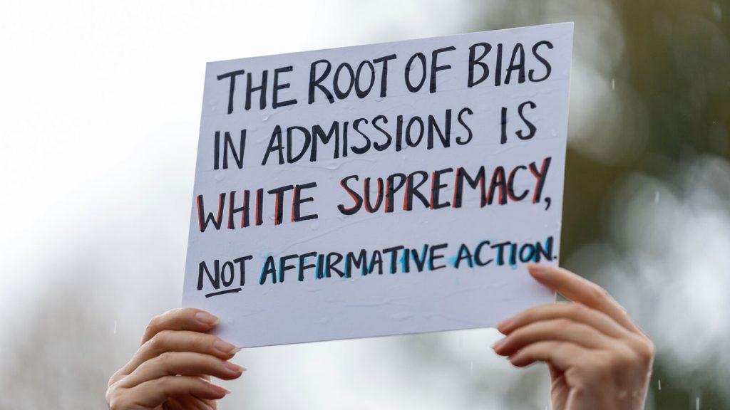 A person holds a sign in support of affirmative action during a rally on Oct. 31 in Washington.
