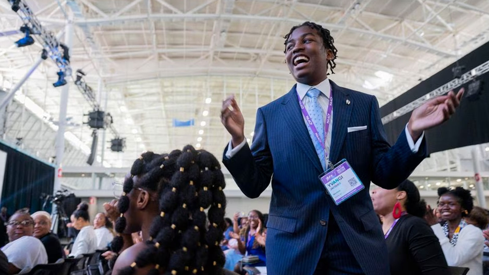 Yvangi Jacques, of Brockton, stood up after winning an award at the 46th NAACP ACT-SO Awards at the NAACP National Convention in Boston Saturday. 