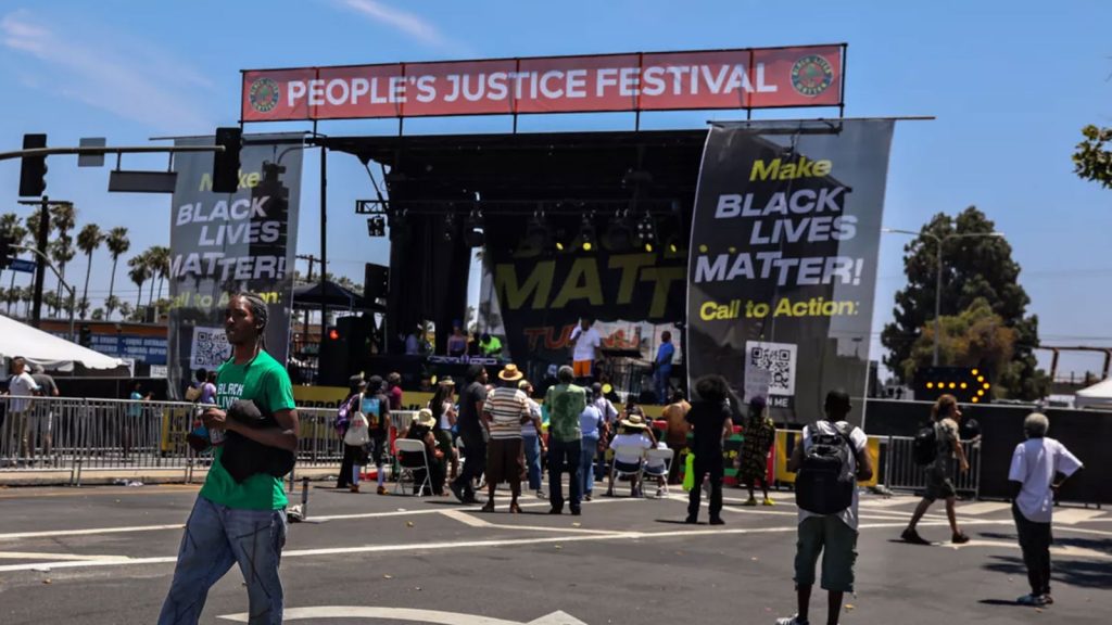 An unexpectedly sparse crowd gathers early Saturday afternoon for the 10th anniversary Black Lives Matter Festival in Leimert Park. More people began arriving later to hear keynote speaker, philosopher Cornel West.