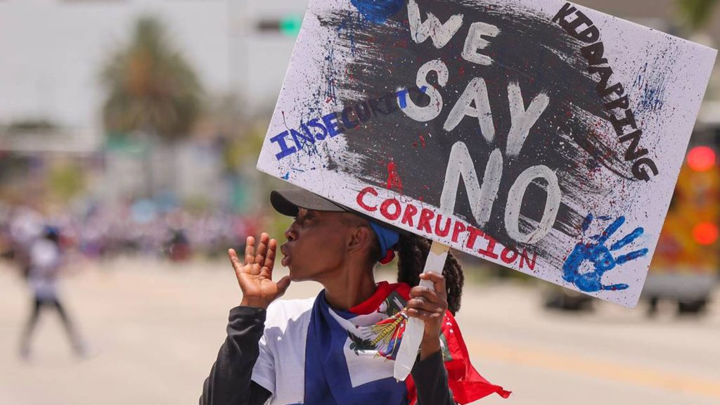 A marcher walks ahead of the large crowd of about 3,500 North Miami residents and members of the South Florida Haitian community as they joined Haitians across the U.S. and the world on Sunday, July 9, 2023 to demand relief for Haiti.