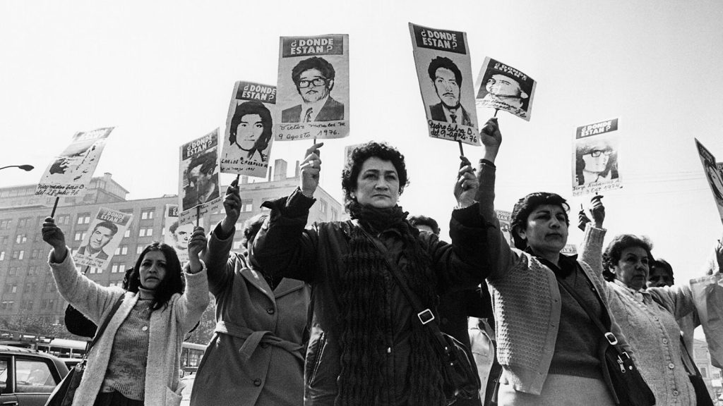 Members of the Association of Families of the Detained-Disappeared demonstrate in front of La Moneda Palace during the Pinochet military regime.