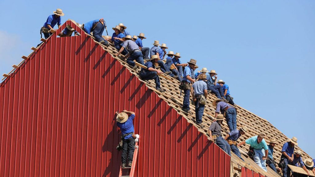 group of construction workers constructing house