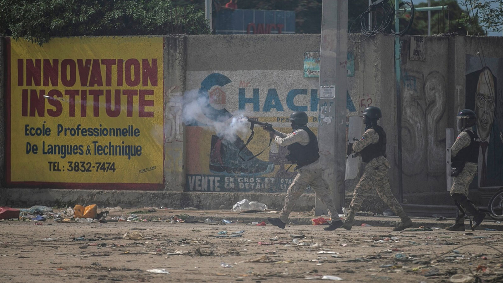 A police officer in Port-au-Prince fires tear gas during a demonstration on Oct. 17, 2022, to reject the international security force requested by Prime Minister Ariel Henry and demand his resignation. 