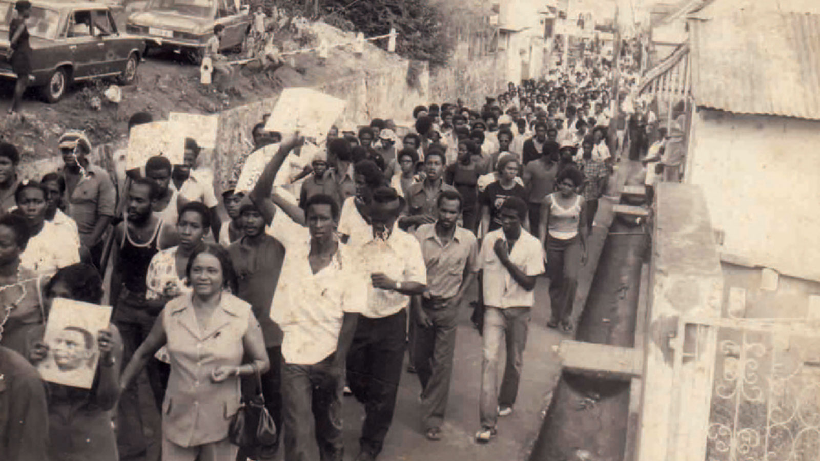 Demonstrators carry photos of Rupert Bishop who was killed on 21 January 1974