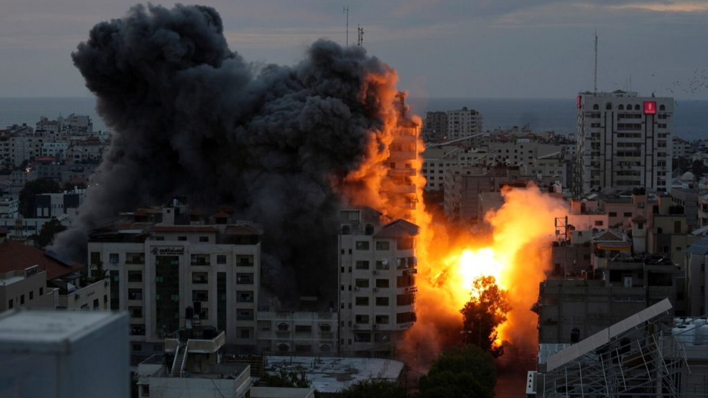 A ball of fire and smoke rise from an explosion on a Palestinian apartment tower following an Israeli airstrike in Gaza City on Oct. 7.