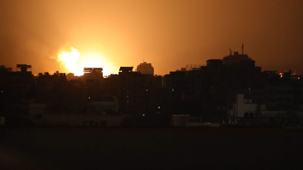The sky lights up as a building is hit during an Israeli airstrike on Gaza City late on Nov. 2, 2023.