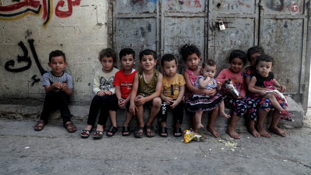 Children sitting near their home at al-Shati camp for Palestinian refugees in the central Gaza Strip on June 20, 2020.