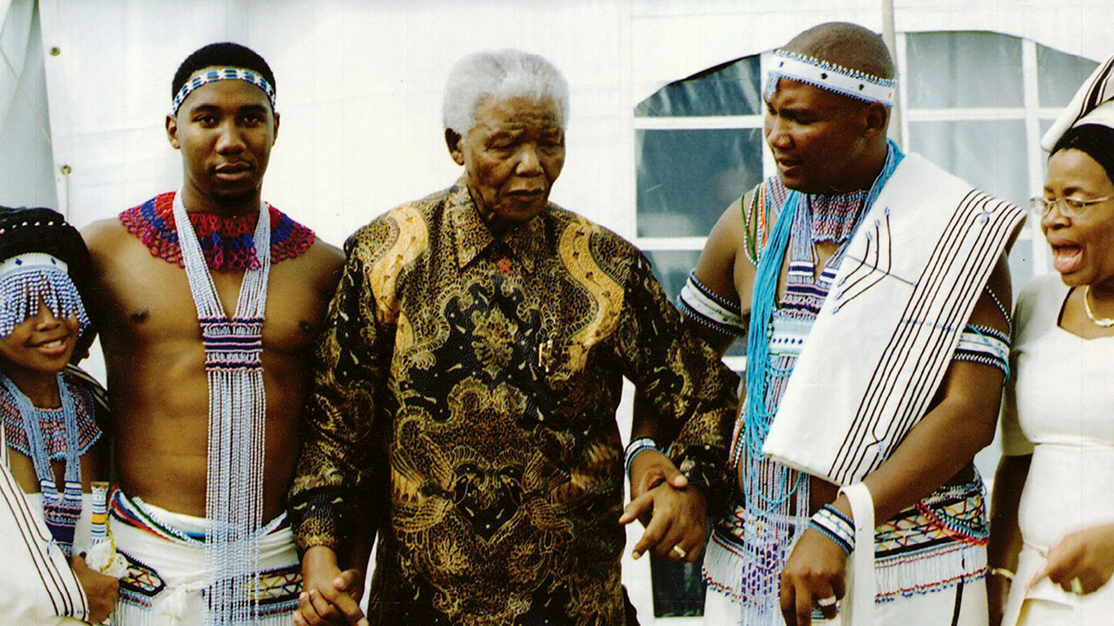 Mandela in his later years attends a traditional wedding alongside grandsons Ndaba and Mandla and wife Graça in Qunu, his childhood village.